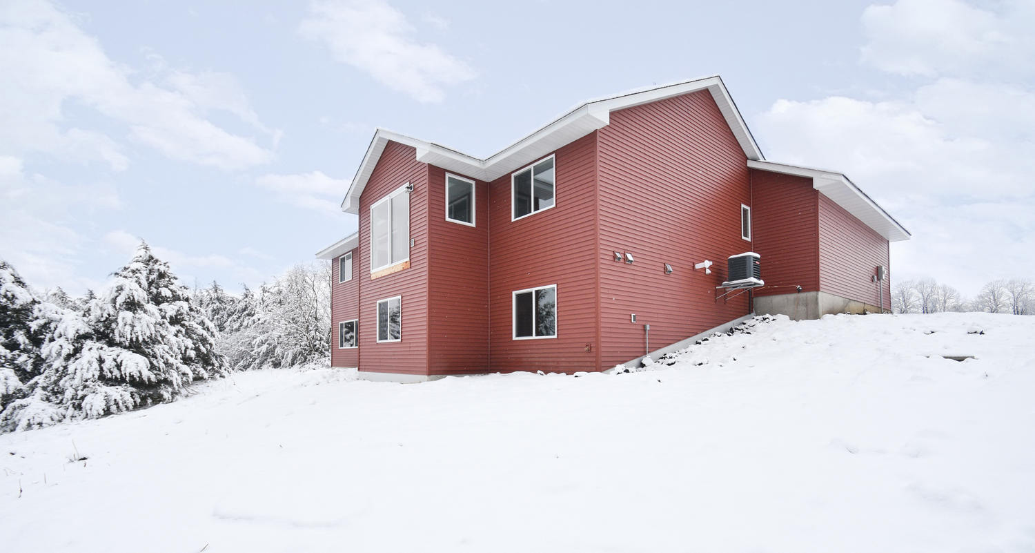 Exterior of red siding home by Christian Builders & Remodelers